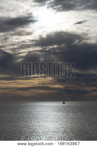 Dramatic Evening Seascape With Sailing Boat On Dark Sea