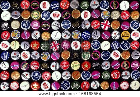 SOUTHAMPTON, UK - 21 Jan 2017: A background of bottle caps from a variety of popular beers, lagers and ciders from around the world. 
