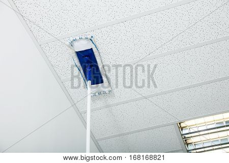 Close-up Of Mop Wiping On The Ceiling Of The House