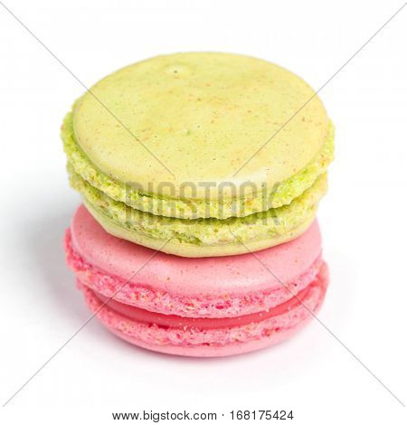 Tasty macaroons in two colors isolated on white background