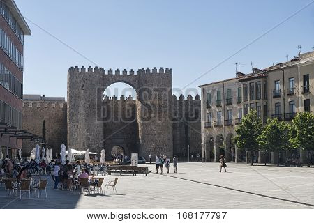AVILA, SPAIN - JULY 23, 2016: Avila (Castilla y Leon Spain): the famous medieval walls surrounding the city from Santa Teresa square with people