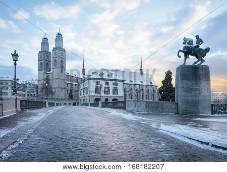 Winter landscape of Zurich. Waldmann monument and Munsterbrucke bridge, Switzerland