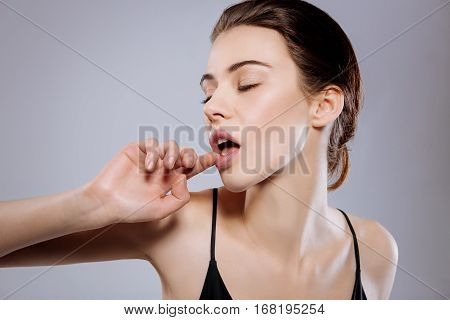 Couture is seductive. Stunning charming young lady striking a pose demonstrating seduction while working in a studio with a photographer