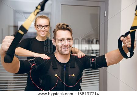 Happy Man Training His Arms With Coach