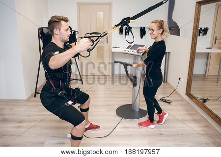 Smiling Satisfied Female Coach Training Man
