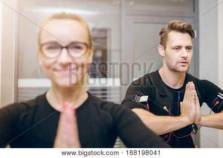 Sportsman And His Coach In Yoga Pose