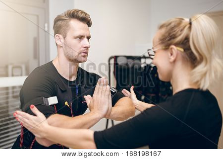 Concentrated Sportsman In Yoga Pose Training With Coach