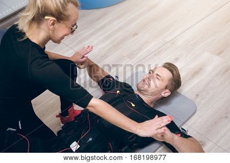 Sportsman Lying On Floor Training With Coach