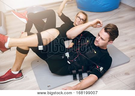 Sportsman Training With Coach On The Floor With Ems