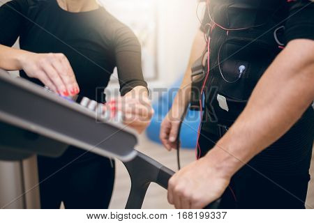 Sportsman And Trainer Hands On Ems Device
