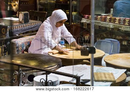 Woman Chef Rolls The Dough With A Rolling Pin