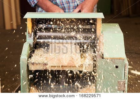 Carpenter tools on wooden table with sawdust. Circular Saw. Carpenter workplace top view.