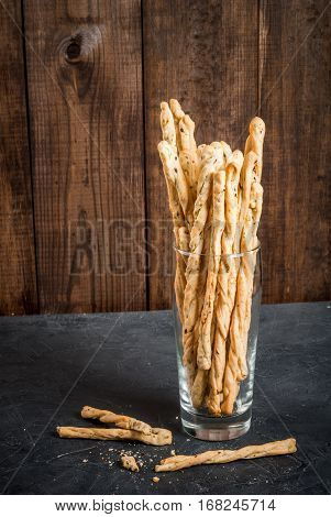 Traditional Italian Snack, Bread - Grizzini. In The Kitchen Chopping Board. On A Dark Stone Table, C
