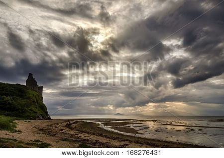 Greenan Castle on beach in cloudy sunset Scotland