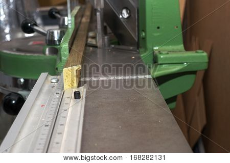 Craftsman working on frame in frameshop. Professional framer hand holding frame angle. Top view.