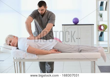 Physiotherapist working with patient in clinic