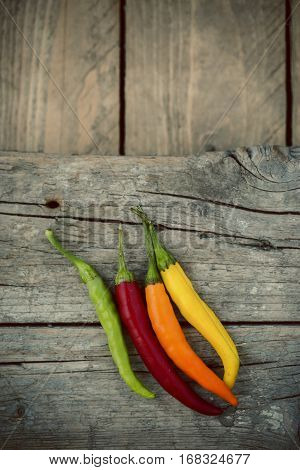 Colorful Chili Peppers  On A Wooden Table