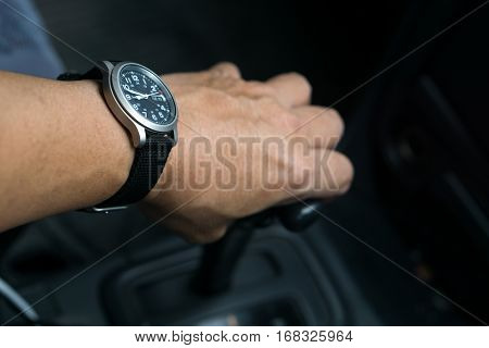driving , left hand and gear with watch.