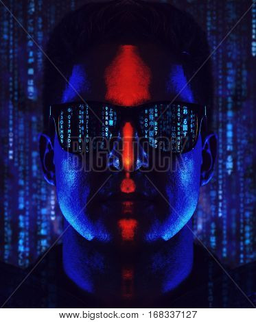 Young cool man program coder in sunglasses portrait. Contrast dramatic blue and red colors and code symbols.