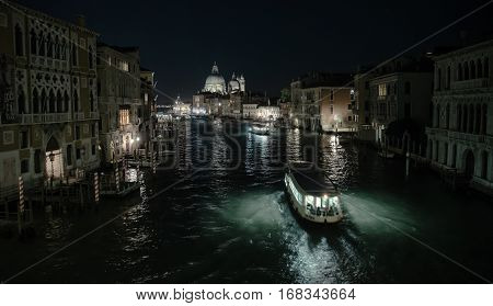 Grand canal in Venice during night  with water bus lighting the water