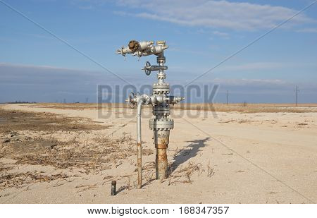 Natural gas wellhead on the sandy seaside