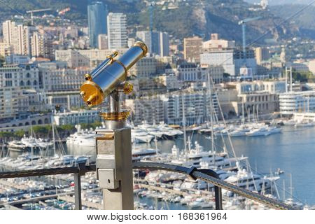 binoculars on observation deck of palace Grimaldi overlooking beach and bay of La Condamine
