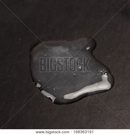 Real sperm puddle on black background