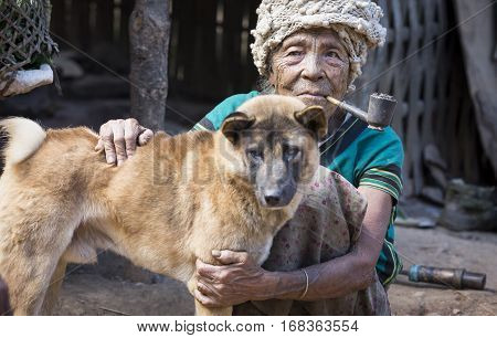 Chin region Myanmar November 11 2014: muun tribe chin lady with her dog