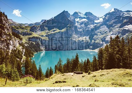 Panorama of the azure pond Oeschinensee. Popular tourist attraction. Picturesque and gorgeous scene. Location Swiss alps, Kandersteg, Bernese Oberland, Europe. Instagram toning effect. Beauty world.