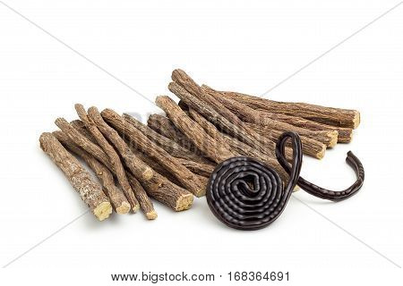 Liqorice roots and black wheel on white background