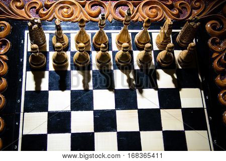 The chess pieces are placed on the chessboard. Defeated black king. The player admitted defeat