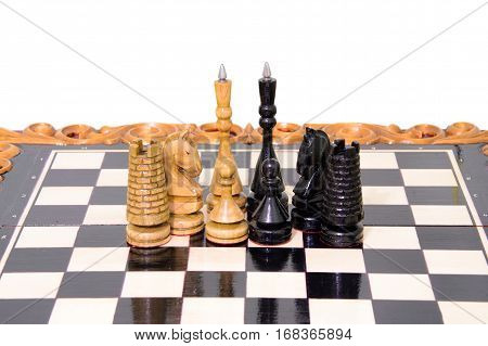 The chess pieces are placed on the chessboard. Defeated black king. The player admitted defeat