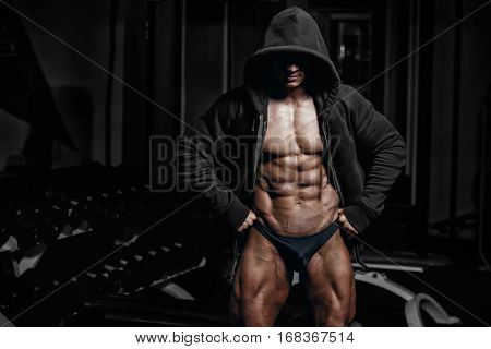Professional bodybuilder posing in gym. Fitness male model