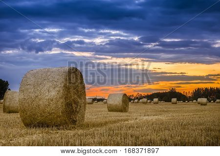 End Of Day Over Field With Hay Bale