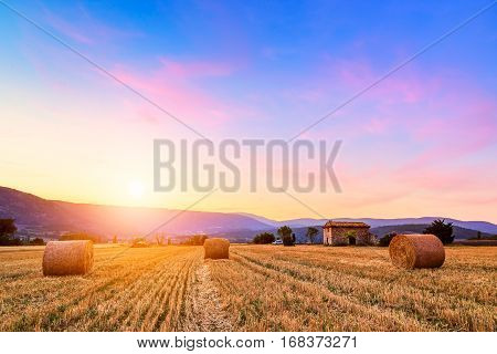 Sunset Over Farm Field With Hay Bales Near Sault