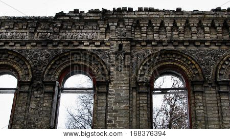Abandoned, broken brick building against the sky