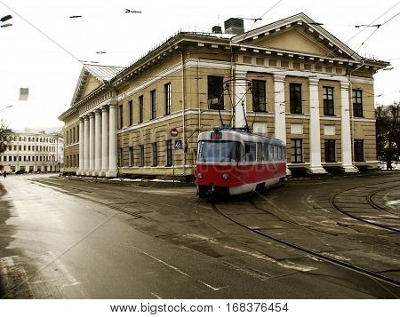 Red tram traveling on city street Kiev Ukraine