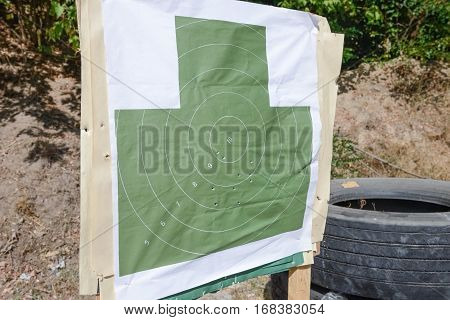 target with bullet holes on the shooting range