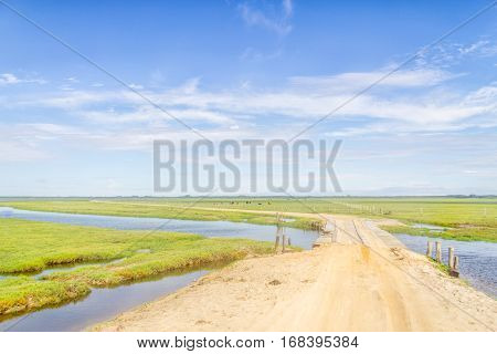 Dirty Road To Lagoa Do Peixe Lake With Wood Bridge