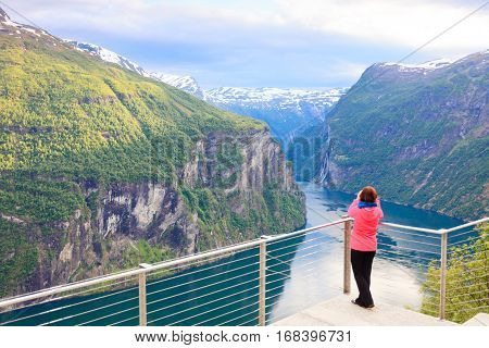 Tourist Looking At Geirangerfjord From Flydasjuvet Viewpoint Norway
