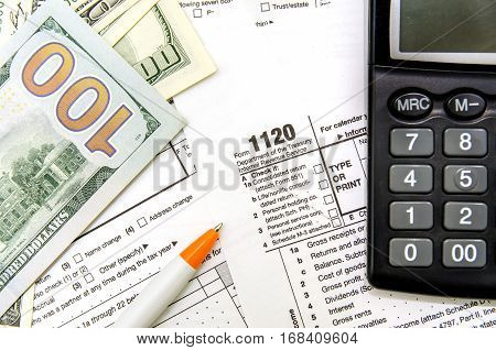 tax form 1120 dollar pen close up
