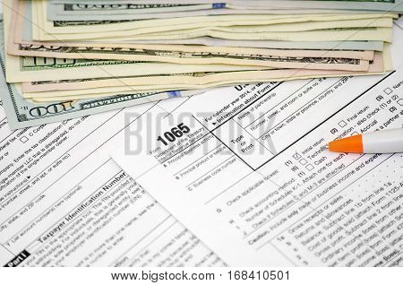 Tax forms 1065 with dollar close up