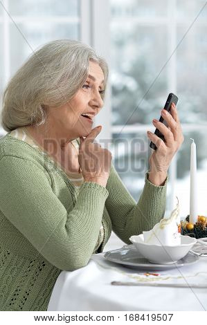 Mature woman in cafe, sitting near window