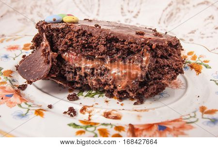 Slices of chocolate cake with strawberries. blueberries cream ganache hazelnut cream nuts cookies.