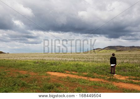Boy alone looking out on a horizen