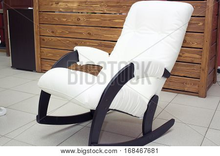 Shot of white leather rocking chair on the floor in color