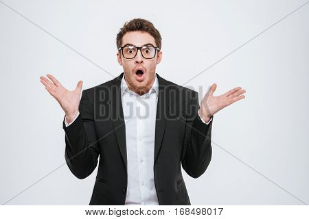 Portrait of a young busnessman looking confused isolated on the white background