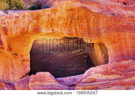 Rose Red Rock Tomb Street of Facades Petra Jordan. Built by the Nabataens in 200 BC to 400 AD. Rose Red canyon walls create many abstracts close up. Inside the Tombs the rose red can become blood red. Reds are created by magnesium in sandstone.