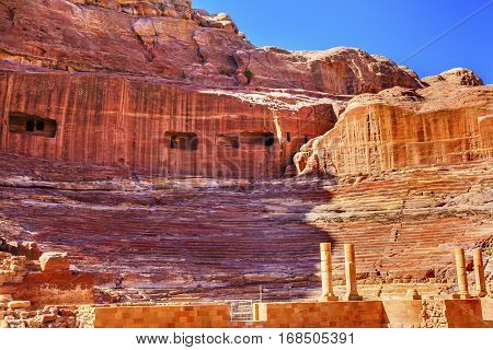 Red Carved Amphitheater Theatre Siq Petra Jordan. Theatre built in Treasury built by the Nabataens in 100 AD and the Romans added to it. The theater is produced from the red stone and seats up to 7000 people.