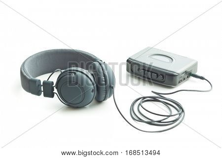 The vintage audio player and headphones isolated on white background.